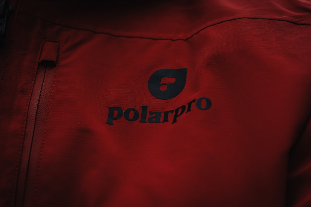 a close up of a person wearing a red jacket — Can You Wear a Polo Shirt to Work? The Business Casual Guide