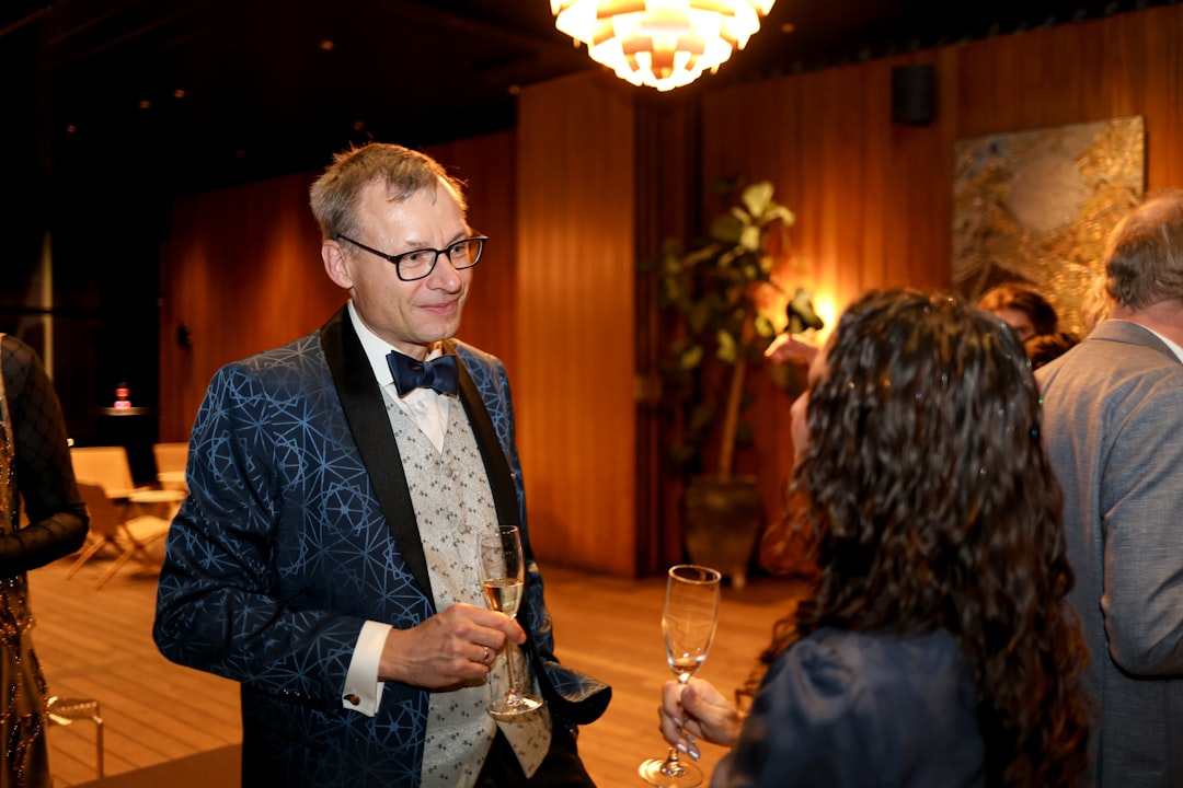 Man in a patterned tuxedo talks to a woman. — What to Wear to a Networking Event: Professional Outfit Guide