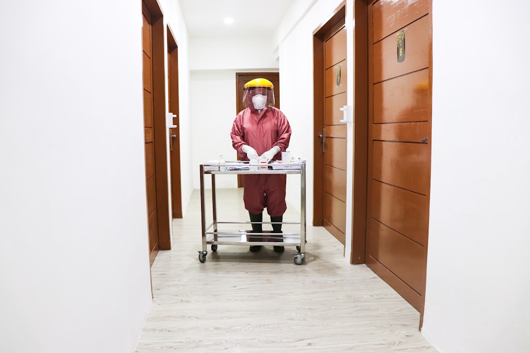 a man in a hard hat and overalls standing in a hallway — How to Care for a Suit: Complete Suit Maintenance Guide